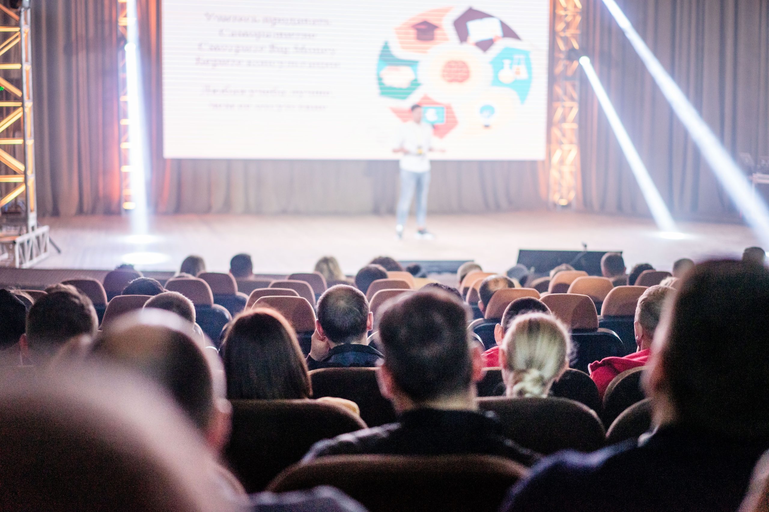 An audience attending a large corporate meeting and seminar conference, planned and coordinated by Selah and Sparrow Travel.